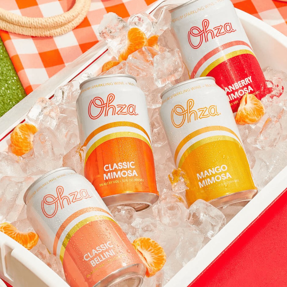 Ohza Classic Mimosa, Mango Mimosa, Cranberry Mimosa and Classic Bellini cans on ice