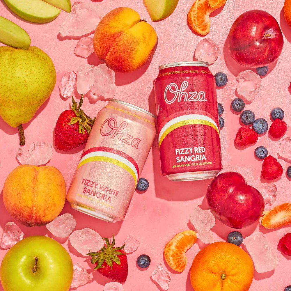 Ohza Fizzy White Sangria and Fizzy Red Sangria cans with fruit